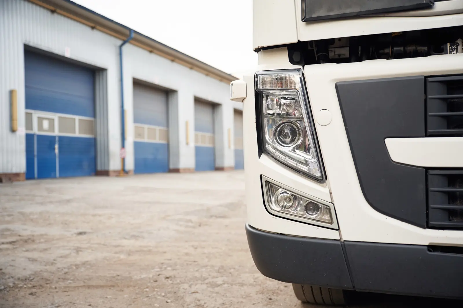 Vantins physical damage truck insurance — close-up of a commercial semi-truck headlight
